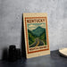 A sign for Kentucky Mountain Parkway, featuring a scenic mountain landscape with a winding road.
