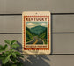 A sign for Kentucky Mountain Parkway is displayed on a wall, featuring a scenic mountain landscape with a winding road.