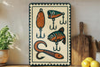 a wall-mounted sign with illustrations of fishing lures and fish, including a large fish, a smaller fish, and a large hook. The sign is surrounded by various kitchen utensils, such as a wooden cutting board and a knife block, as well as some lemons.