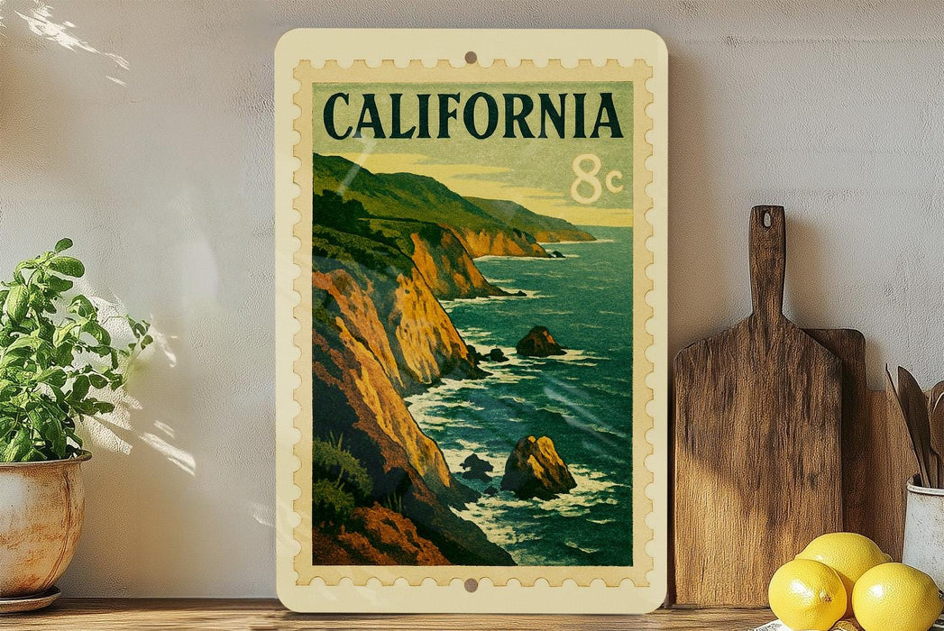 A framed vintage postage stamp depicting a scenic coastal landscape in California, with mountains, cliffs, and the ocean in the background.