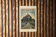 A vintage postage stamp from the city of Mont-Saint-Michel, France, featuring a castle and a bridge.