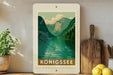 a framed poster of a scenic mountain landscape with a lake, surrounded by potted plants and kitchen utensils.