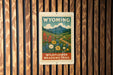 A poster for the Wildflower Meadows Trail in Wyoming, featuring a scenic landscape with mountains, flowers, and a winding path.