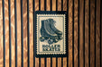 A sign with a roller skate illustration is mounted on a wooden wall.