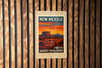 A vintage-style poster of the Sunset Vista Point in New Mexico, featuring a desert landscape with mountains in the background and a sunset over the horizon.