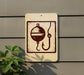 a sign with a fishing symbol, including a bobber and a fishing line, mounted on a wall.