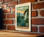 A Tennessee postage stamp depicting a scenic waterfall, mounted on a brick wall.