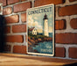 A vintage-style poster of a lighthouse on a brick wall, with the text "Connecticut USA Forever" below it.
