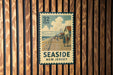 A vintage seaside postcard from New Jersey, featuring a wooden pier and people enjoying the beach.