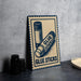 A sign with the text "GLUE STICKS" and an illustration of two glue sticks is displayed on a table.