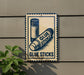 A sign on a wall that says "GLUE STICKS" with an illustration of two glue sticks.
