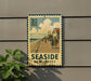 A vintage-style metal sign with a beach scene and people walking along the boardwalk, mounted on a wall.