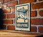 A vintage-style metal sign with a musical instrument on it, mounted on a brick wall.