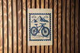 a bicycle on a sign with mountains in the background.