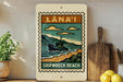 A vintage-style sign for "Lana'i Shipwreck Beach" is displayed on a wall, featuring a ship illustration and the text "Lana'i Shipwreck Beach".