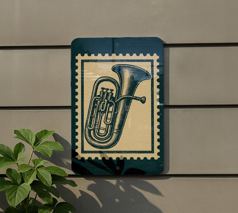 a green sign with a picture of a tuba on it, mounted on a wall.
