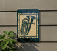 a green sign with a picture of a tuba on it, mounted on a wall.