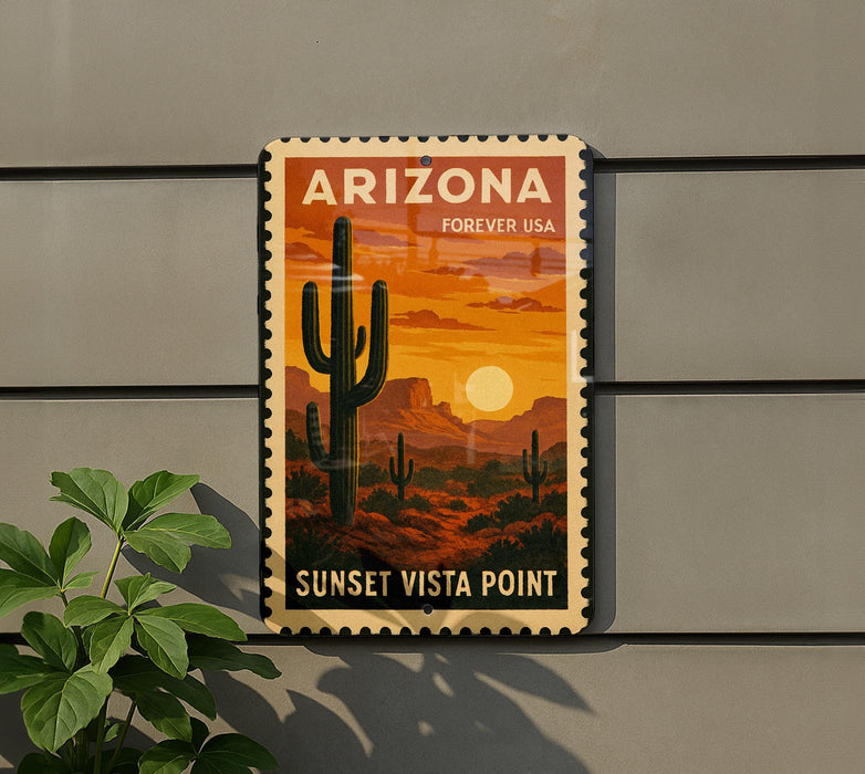 A vintage-style Arizona postage stamp featuring a desert landscape with a cactus and a sunset in the background, mounted on a wall.