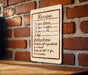 A recipe sign is hanging on a brick wall, providing instructions for a cake recipe.