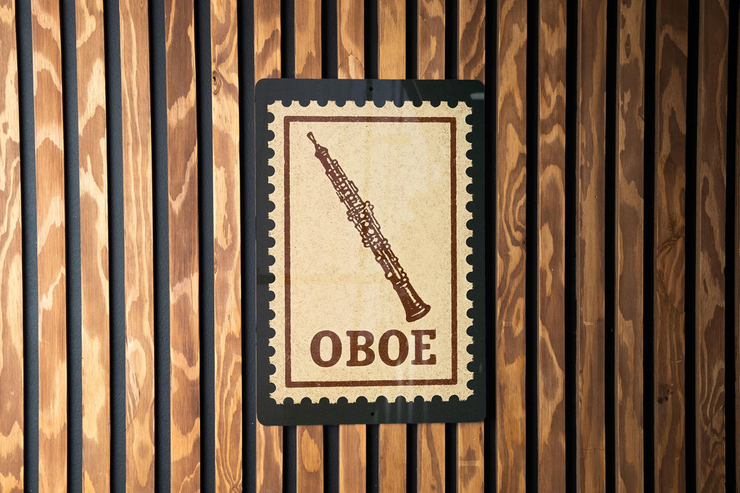a sign with the word "OBOE" on it, which is mounted on a wooden wall.