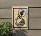 a brass instrument, specifically a tuba, mounted on a wall.