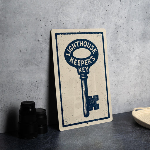 a metal sign with a key design, placed on a countertop next to some black camera lenses.