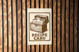 a sign that reads "RECIPE CARD" with an illustration of a recipe book.