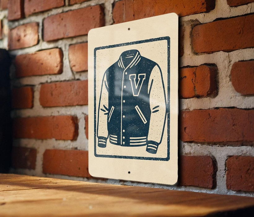 A sign with a graphic of a v-shaped jacket is mounted on a brick wall.