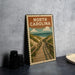 A metal sign with a wooden walkway leading to a beach, featuring the text "NORTH CAROLINA" and an illustration of a beach and sky.
