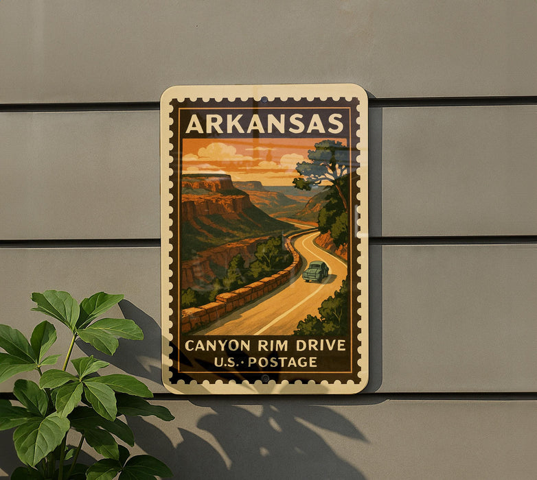 A vintage-style postage stamp from Arkansas, depicting a scenic road leading to a canyon, is displayed on a wall.