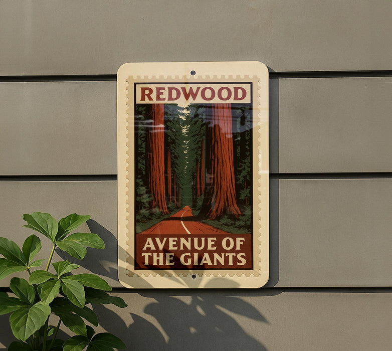 a sign that reads "REDWOOD AVENUE OF THE GIANTS" with a picture of a road leading through a forest of tall trees.