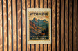 A poster of the High Country overlooks in Wyoming is displayed on a wooden wall.
