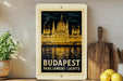 A framed vintage poster of the Hungarian Parliament Lights in Budapest, featuring the iconic Buda Castle and the River Danube.