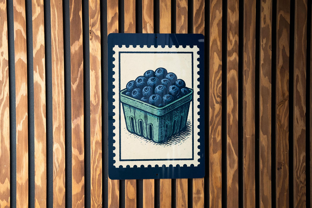 A blue and white illustration of a basket filled with blueberries is displayed on a wooden wall.