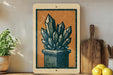 a wooden shelf with a framed illustration of a crystal formation, a potted plant, and a wooden cutting board.
