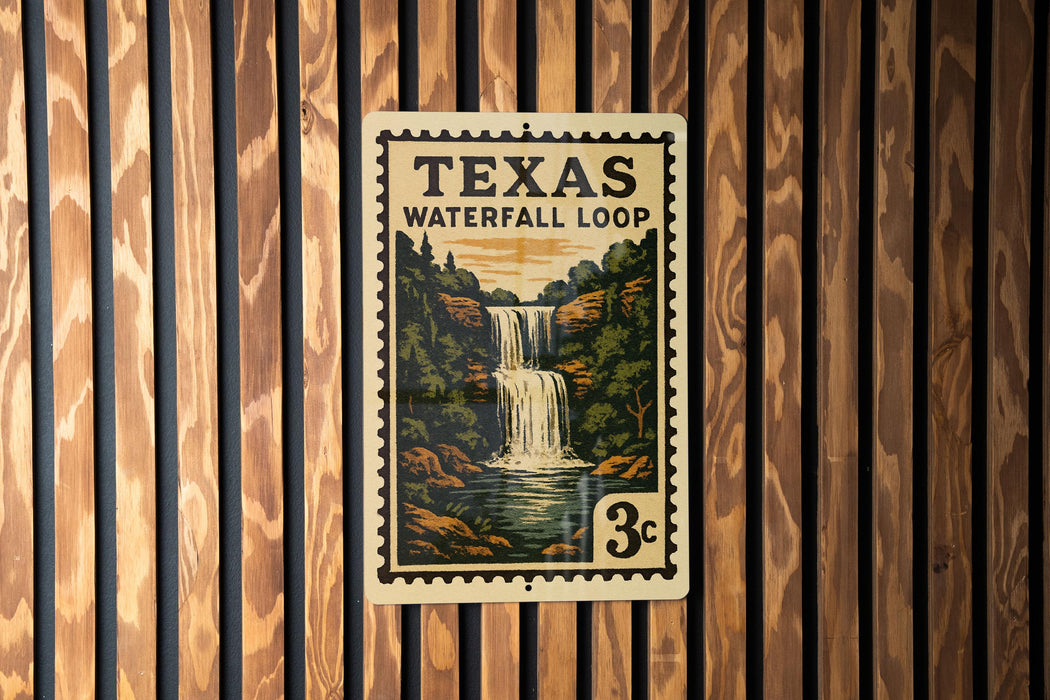 A Texas Waterfall Loop postage stamp is displayed on a wooden wall.