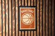 A basketball-themed sign is displayed on a wooden wall.