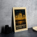 A poster of the Hungarian Parliament Lights, a famous landmark in Budapest, Hungary, is displayed on a wall.