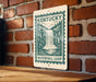 A sign for Kentucky's Waterfall Loop is displayed on a brick wall.
