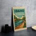 A poster or sign for Idaho Riverwalk promenade, featuring a scenic illustration of a river, park, and lamppost.