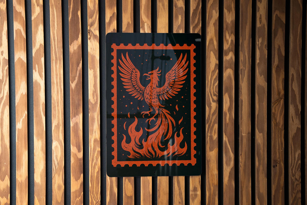 a black and orange graphic design on a wooden wall, depicting a phoenix with its wings spread wide.