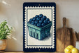 A framed illustration of a blueberry basket on a shelf, with a wooden cutting board and a potted plant to the left.