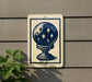 a sign with a blue and white design depicting a starry sky on a white background, mounted on a gray wall.