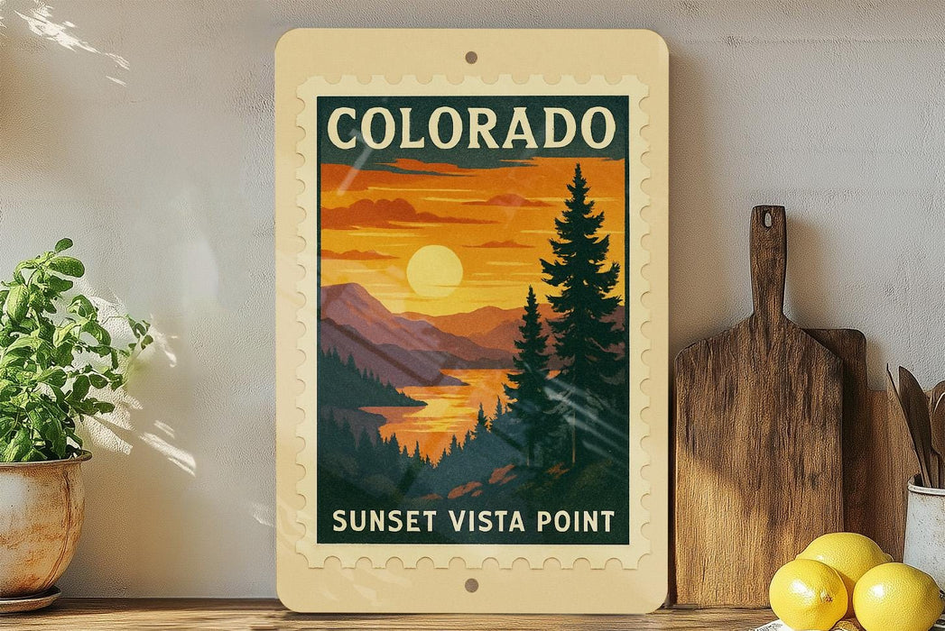 A framed vintage-style poster of the sunset over the mountains of Colorado, with the text "SUNSET VISTA POINT" printed on it. The poster is displayed on a shelf next to a wooden cutting board and a potted plant.