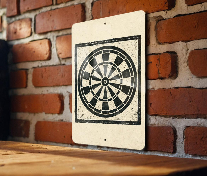 A white sign with a black and white dartboard design is mounted on a brick wall.