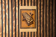 a sign with a musical instrument, specifically a xylophone, mounted on a wooden wall.