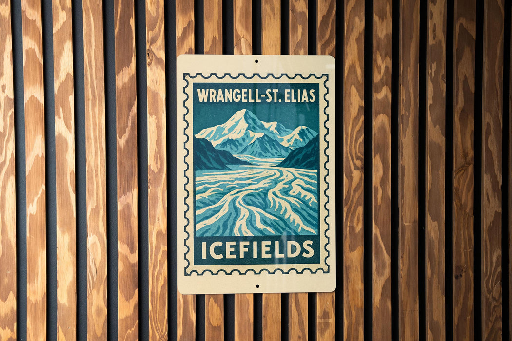 A vintage-style sign for Wrangell-St. Elias Icefields, featuring a mountain landscape and a river, is displayed on a wooden wall.