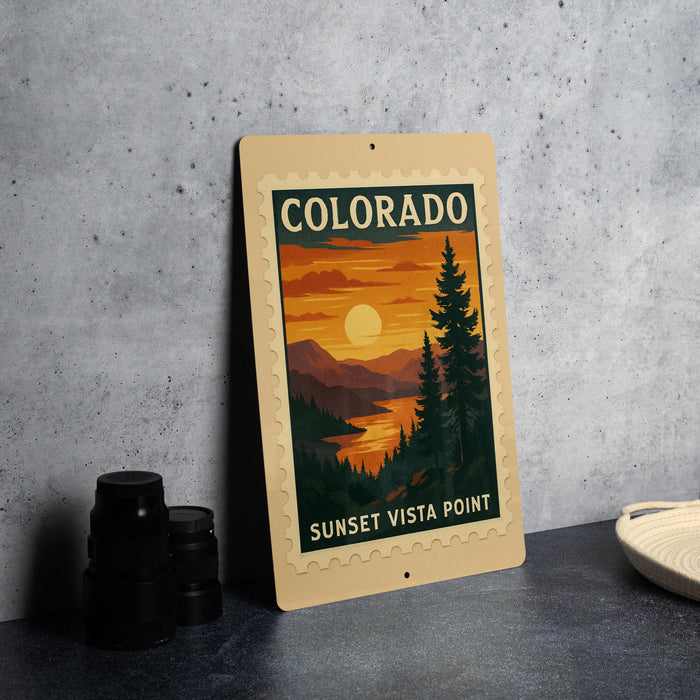 A framed poster of a sunset landscape with mountains and pine trees, featuring the text "COLORADO SUNSET Vista Point" on the poster.