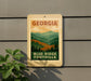 A sign for Blue Ridge Foothills in Georgia, featuring a scenic mountain landscape.
