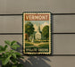 A vintage-style sign for Vermont Village Greens, featuring a pastoral scene with a church, houses, and trees.